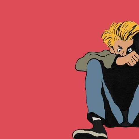 Blonde kid sitting on red